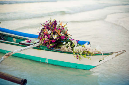 Philippine boat and a bouquet of flowers. Wedding in the tropics concept.の写真素材