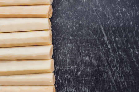 Pieces of cane sugar on the old wooden background. Sugar concept.の写真素材