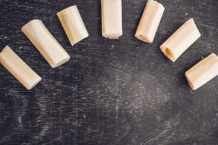 Pieces of cane sugar on the old wooden background. Sugar concept.の写真素材