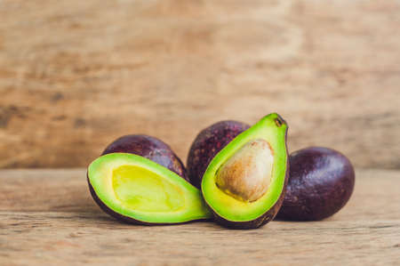 Fresh organic avocado on dark old wooden table, Organic vegetarian food concept