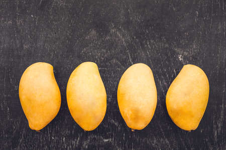Mango fruit on the wooden table. Tropical fruit concept.
