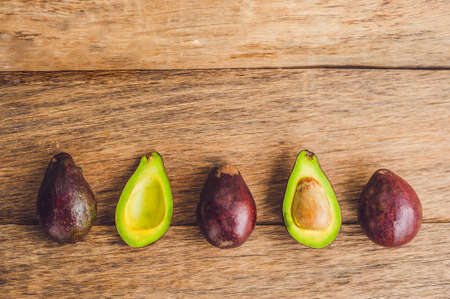 Fresh organic avocado on dark old wooden table, Organic vegetarian food conceptの写真素材