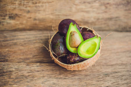 Fresh organic avocado on dark old wooden table, Organic vegetarian food concept