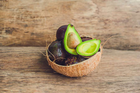 Fresh organic avocado on dark old wooden table, Organic vegetarian food conceptの写真素材