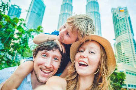 Selfies family on the background of skyscrapers. tourism, travel, people, leisure and technology concept.の写真素材