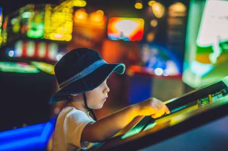 The boy looks an electronic map of the sky on the screen.の写真素材