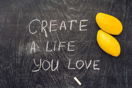 Create life you love motivational advice - text on a slate blackboard with chalk.の写真素材