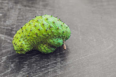 Guanabana on an old wooden background - exotic tropical fruit - regional fruits from Vietnam.の写真素材
