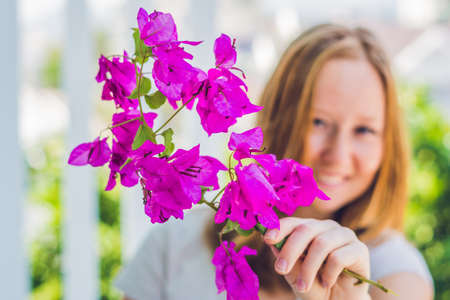 Young woman with spring purple flowers.の写真素材