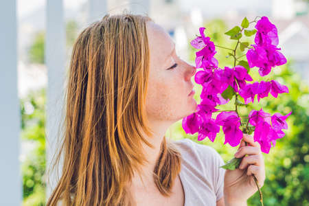 Young woman with spring purple flowers. Spring concept.