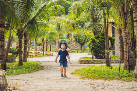 Boy traveler walks in the park in Asia.の写真素材