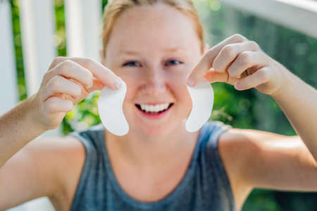 Portrait of Beauty Red-haired woman with eye patches showing an effect of perfect skin.の写真素材