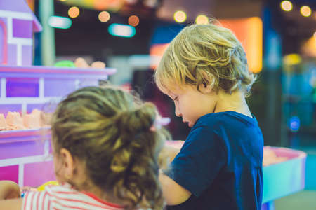 Boy playing with kinetic sand in preschool. The development of fine motor concept. Creativity Game concept.の写真素材