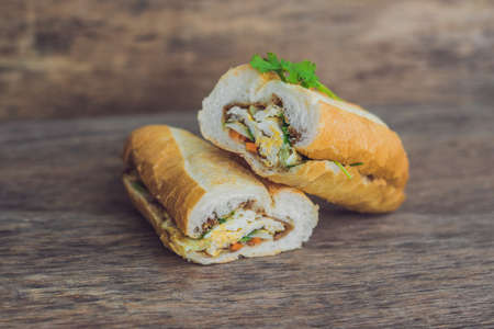 A delicious Vietnamese Bahn Mi sandwich on a wooden background.の写真素材