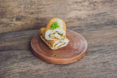 A delicious Vietnamese Bahn Mi sandwich on a wooden background.の写真素材