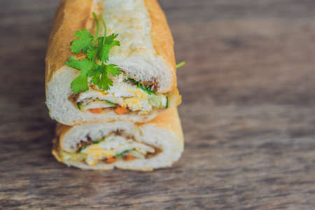 A delicious Vietnamese Bahn Mi sandwich on a wooden background.の写真素材
