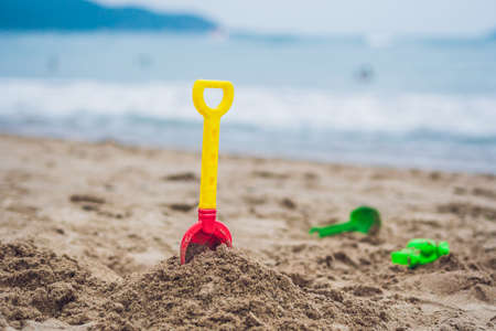 Children's beach toys - shovel on sand against the seaの写真素材