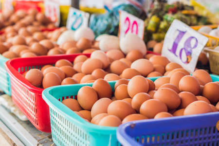 The eggs - chicken and quail in the wicker basket on the Vietnamese market. Asian food concept.の写真素材