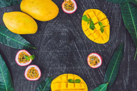 Mango and passion fruit on an old wooden background. Copy space.の写真素材
