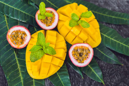 Mango and passion fruit on an old wooden background.の写真素材