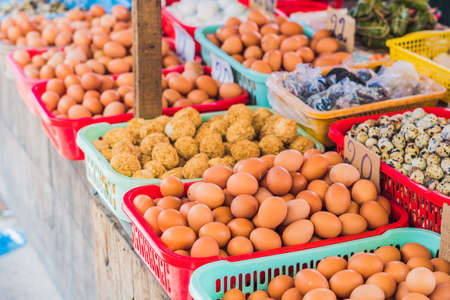 The eggs - chicken and quail in the wicker basket on the Vietnamese market. Asian food concept.の写真素材