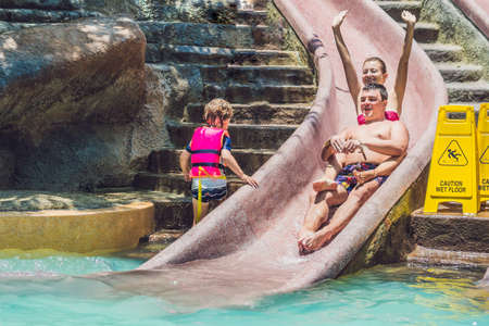 woman and man going down a water slide.