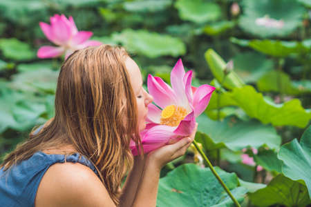 picture of beautiful woman Red-haired with lotus flower in hand.の写真素材