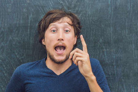 Top view of a young man with space for text and symbols on the old wooden background. Concept for confusion, brainstorming and choice.の写真素材