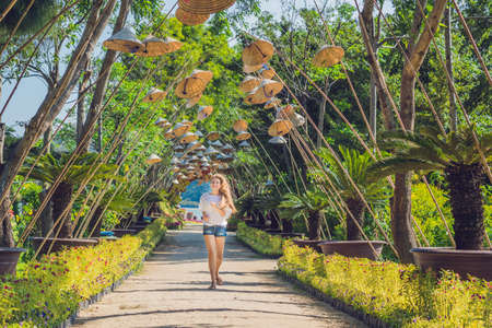 Young woman tourist and Vietnamese hats. Travel around Vietnam concept.の写真素材