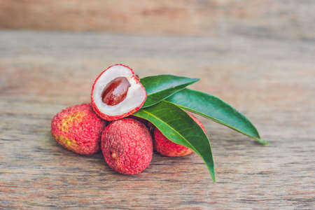 Fresh litchi fruit on an old wooden background.の写真素材