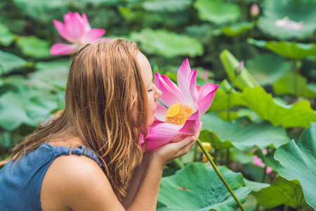 picture of beautiful woman Red-haired with lotus flower in hand.の写真素材