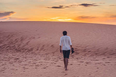 A man lost in the red desert in Vietnam, Mui Ne.の写真素材
