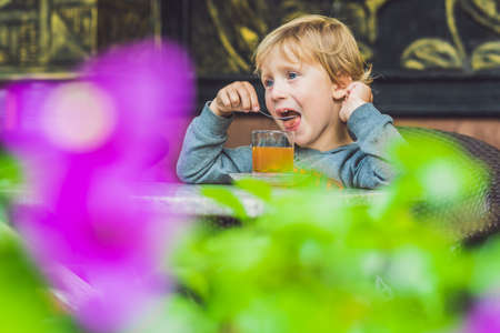 Cute little boy drinking tea in cafeteria.の写真素材