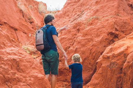 Father and son travelers in red canyon near Mui Ne, southern Vietnam. Traveling with children concept.の写真素材