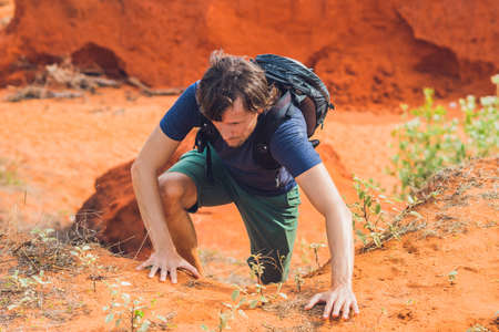 Young man in red canyon near Mui Ne, southern Vietnam.の写真素材