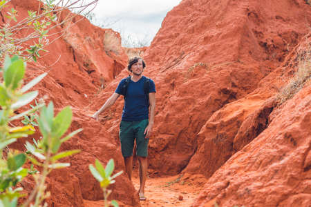 Young man in red canyon near Mui Ne, southern Vietnam.の写真素材