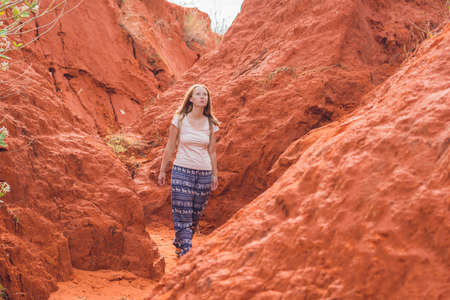 Young woman in red canyon near Mui Ne, southern Vietnam.の写真素材