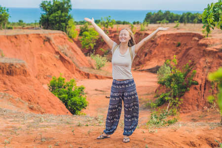 Young woman in red canyon near Mui Ne, southern Vietnam.の写真素材
