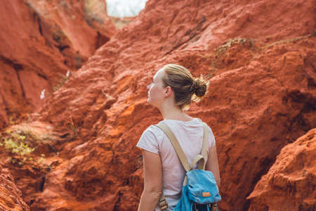 Young woman in red canyon near Mui Ne, southern Vietnam.の写真素材