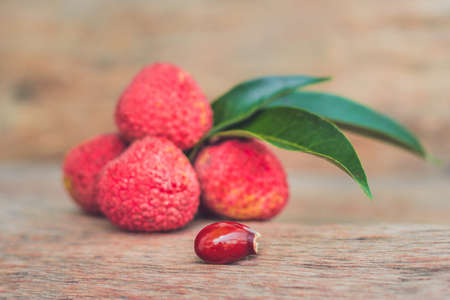 Fresh litchi fruit on an old wooden background.の写真素材