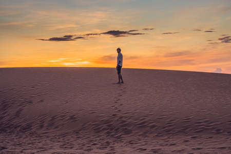 A man lost in the red desert in Vietnam, Mui Ne.の写真素材
