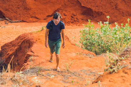 Young man in red canyon near Mui Ne, southern Vietnam.の写真素材