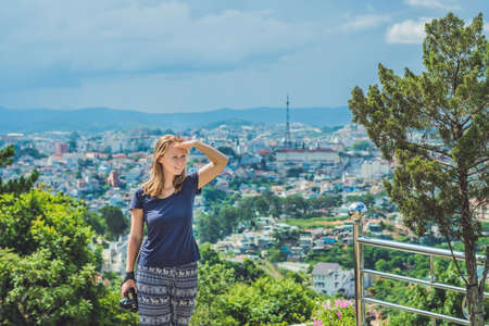 Young female traveler enjoying great view of Dalat City, Vietnam.の写真素材