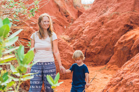 Mother and son travelers in red canyon near Mui Ne, southern Vietnam. Traveling with children concept.の写真素材