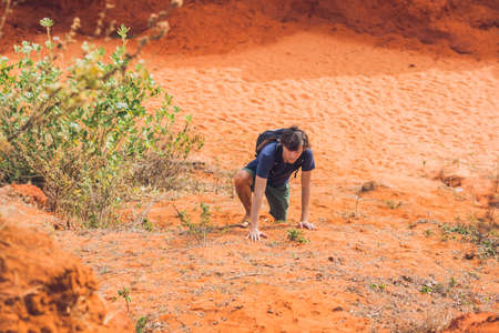 Young man in red canyon near Mui Ne, southern Vietnam.の写真素材