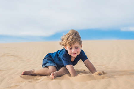 Boy in the desert. Traveling with children concept.の写真素材