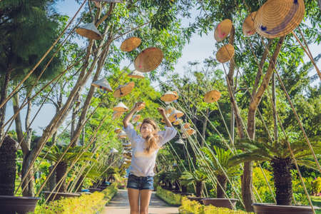 Young woman tourist and Vietnamese hats. Travel around Vietnam concept.の写真素材