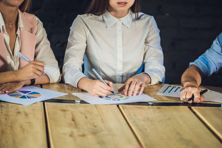 Young team of coworkers making great meeting discussion in modern coworking office. Teamwork process. Horizontal,blurred background.の写真素材