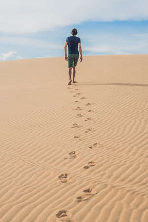 A man is walking in the desert Vietnam, Mui Ne.の写真素材