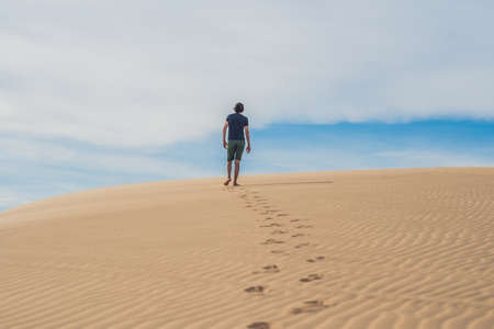 A man is walking in the desert Vietnam, Mui Ne.の写真素材